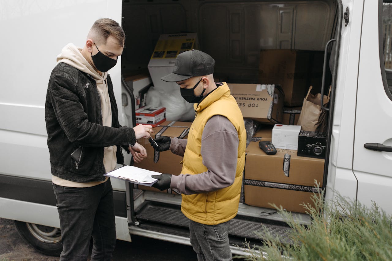 Courier wearing face mask delivers packages to a customer maintaining safety protocols.
